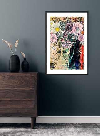 Framed "Flowers and Colors" poster featuring vibrant floral artwork, displayed on a dark wall above a wooden dresser.