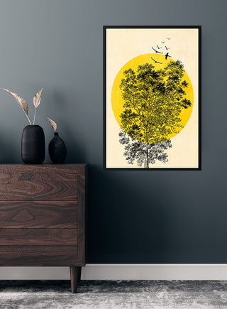 Framed poster of a yellow sun, black birds, and tree on a dark wall above a wooden dresser.
