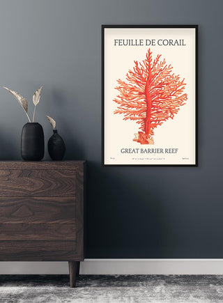 Framed Feuille De Corail No. 04 Plakat featuring a red coral illustration hangs on a dark wall above a dresser.