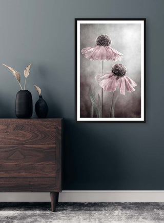 Framed Duet by Mandy Disher featuring two pink flowers, displayed above a wooden dresser in a modern room.