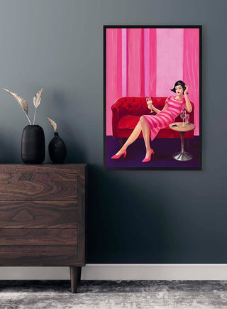 Before Dinner by Kate Aitana framed on a dark wall, above a wooden dresser with vases and dried grasses.