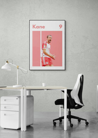 Poster of Harry Kane in a Bayern Munich kit with his name and number 9, displayed above an office desk.