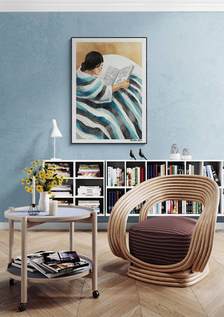 Framed "Moment of Peace - Martin Zen" art above modern chair in cozy, stylish reading nook.