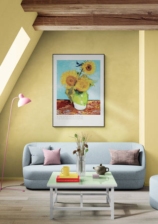 Framed Van Gogh "Vase With Flowers" artwork hanging above a modern sofa in a stylish living room.