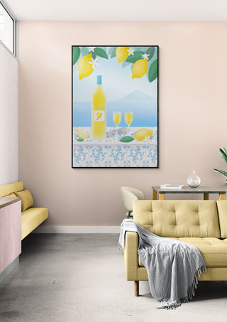 Framed Limoncello art print with lemons and bottles, displayed above a modern beige sofa in a stylish living room.