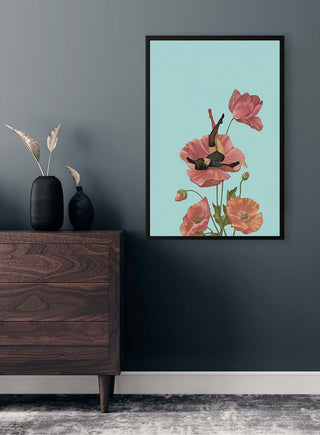 Art print of pink flowers with a figure reclining inside, displayed on a wall above a wooden dresser.