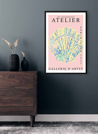 Framed Art Shell Exhibition 2022 poster by Vincent V. displayed above a wooden dresser on a dark wall.