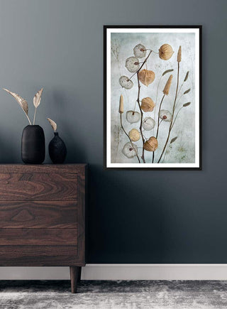 Framed Lanterns 02 artwork by Mandy Disher displayed above a wooden dresser in a modern room.