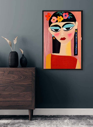 Colorful portrait art print of a woman with flowers in her hair, displayed above a modern wooden dresser.