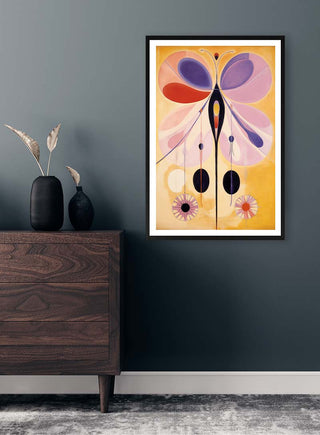 Framed Fly Butterfly - Tara Green artwork with abstract butterfly design, displayed above a wooden dresser.