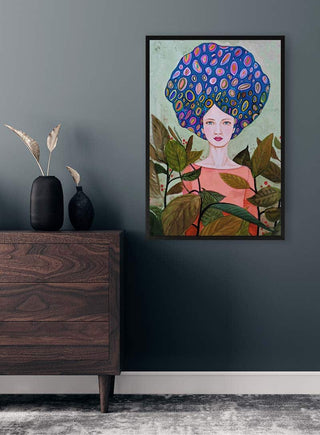 Framed Claire by Sylvie Demers artwork on a dark wall above a wooden dresser with decorative vases and plants.