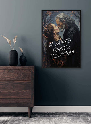 Framed "Always Kiss Me Goodnight - David Wolf" poster featuring a romantic couple, displayed above a dresser.