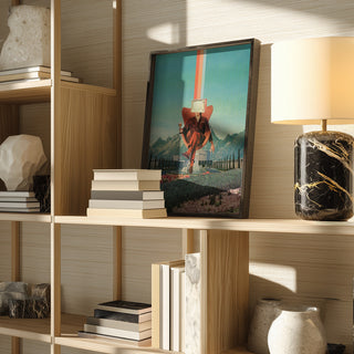 Framed Enemy - Frank Moth artwork displayed on a wooden shelf beside books, decor items, and a lamp.