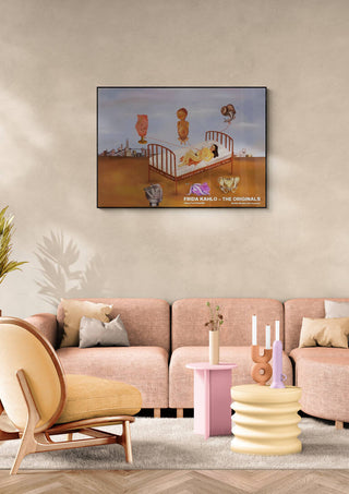 Frida Kahlo's "Henry Ford Hospital" painting displayed above a pastel modern sofa in a stylish living room.