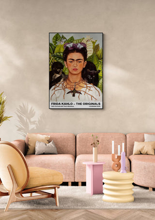 Framed Frida Kahlo "Thorn Necklace" portrait hanging above a modern pastel living room sofa.
