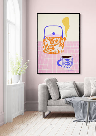 Framed Baroo Bloom art print featuring a teapot and teacup, displayed above a modern sofa in a bright room.