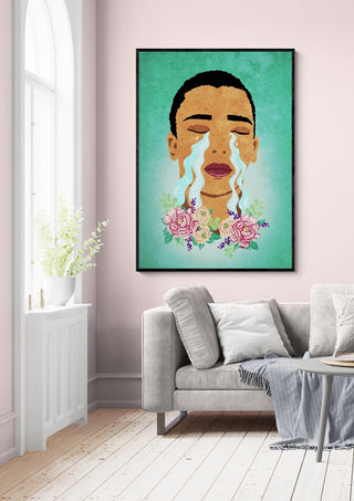 A framed print of Boys do cry by Raissa Oltmanns hangs above a gray sofa in a pastel living room.