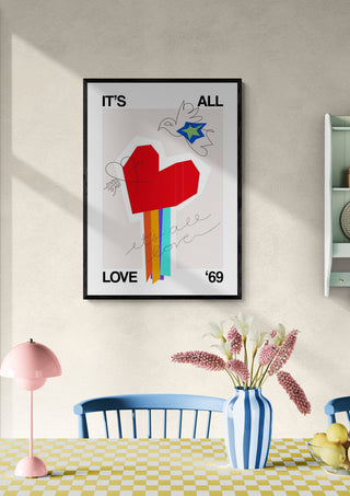 Framed "All Love White" poster with a red heart and rainbow on a wall above a dining table.