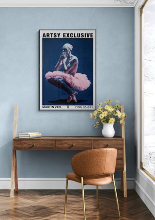 Poster of a ballet dancer in pink with "ARTSY EXCLUSIVE," above a desk and chair in a modern room.