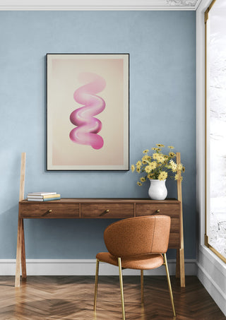 Retro Graphic No.6 art print with abstract pink swirl, displayed above a wooden desk in a modern room.
