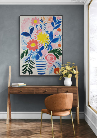 Framed "Modern Flowers" by David Wolf above a wooden desk and chair in a stylish, contemporary room.