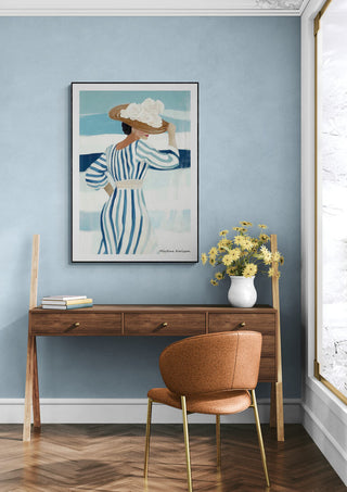 Framed "Summer Time" by Martina Karlsson hanging above a wooden desk with flowers in a modern room.