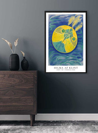Framed print of Hilma Af Klint's "Primordial Chaos" hanging on a dark wall above a wooden dresser.