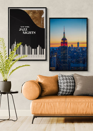 Blue Manhattan - Danny Gao wall art featuring the Empire State Building above a modern tan sofa and decorative pillows.
