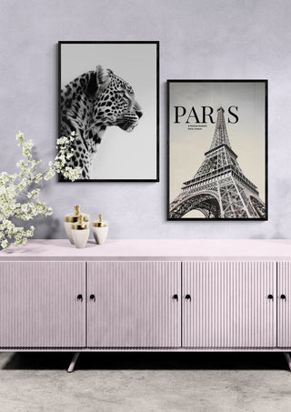 Framed Paris Eiffel Tower Artsy Edition print displayed above a modern pink cabinet in a stylish room.