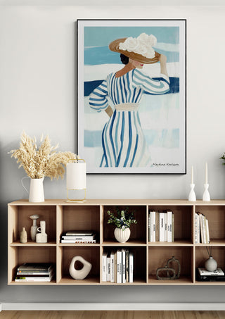 Framed "Summer Time" by Martina Karlsson above a modern shelf with decor and books in a bright living room.