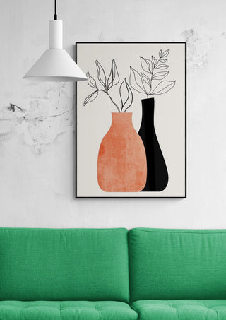 Framed "Madame a Monsieur" artwork by Boris Draschoff above a green sofa and under a white pendant lamp.