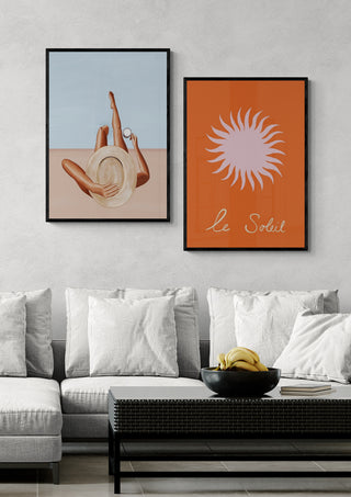 Framed Woman with Strawberries - Ivy Green artwork displayed above a modern sofa in a stylish living room.