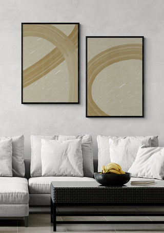 Two framed Clay Motion I - Yuli abstract art prints on a wall above a modern sofa with neutral decor.