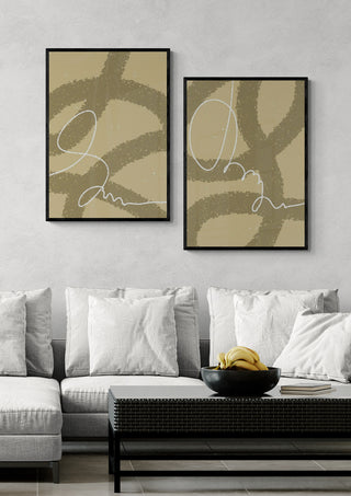 Two framed Drift Loop I - Yuli abstract prints hang above a modern sofa with neutral cushions.