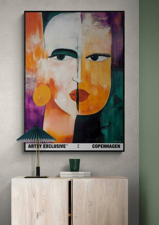 Abstract portrait artwork "Duality" by Martin Zen with bold colors, displayed above a cabinet in a modern interior.