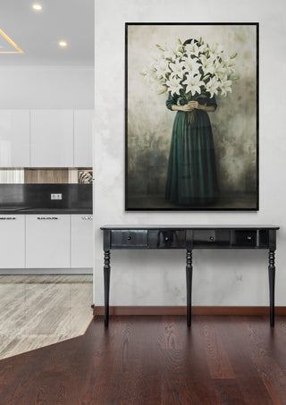 Framed Lilies artwork by Annika Persson hanging above a black console table in a modern living space.